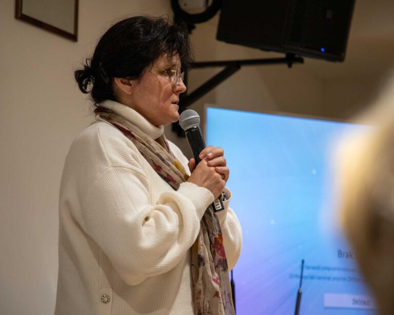 a woman speaking into a microphone